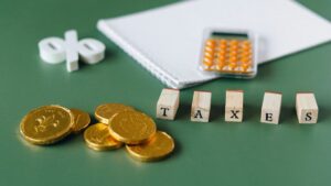 Coins, calculator and dices representing the tax season