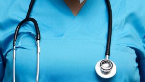 Health workers in the UK wearing blue scrubs